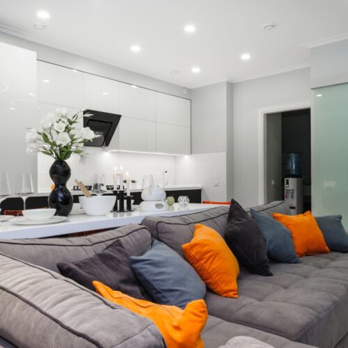 Modern designer white living studio with bedroom doors open
